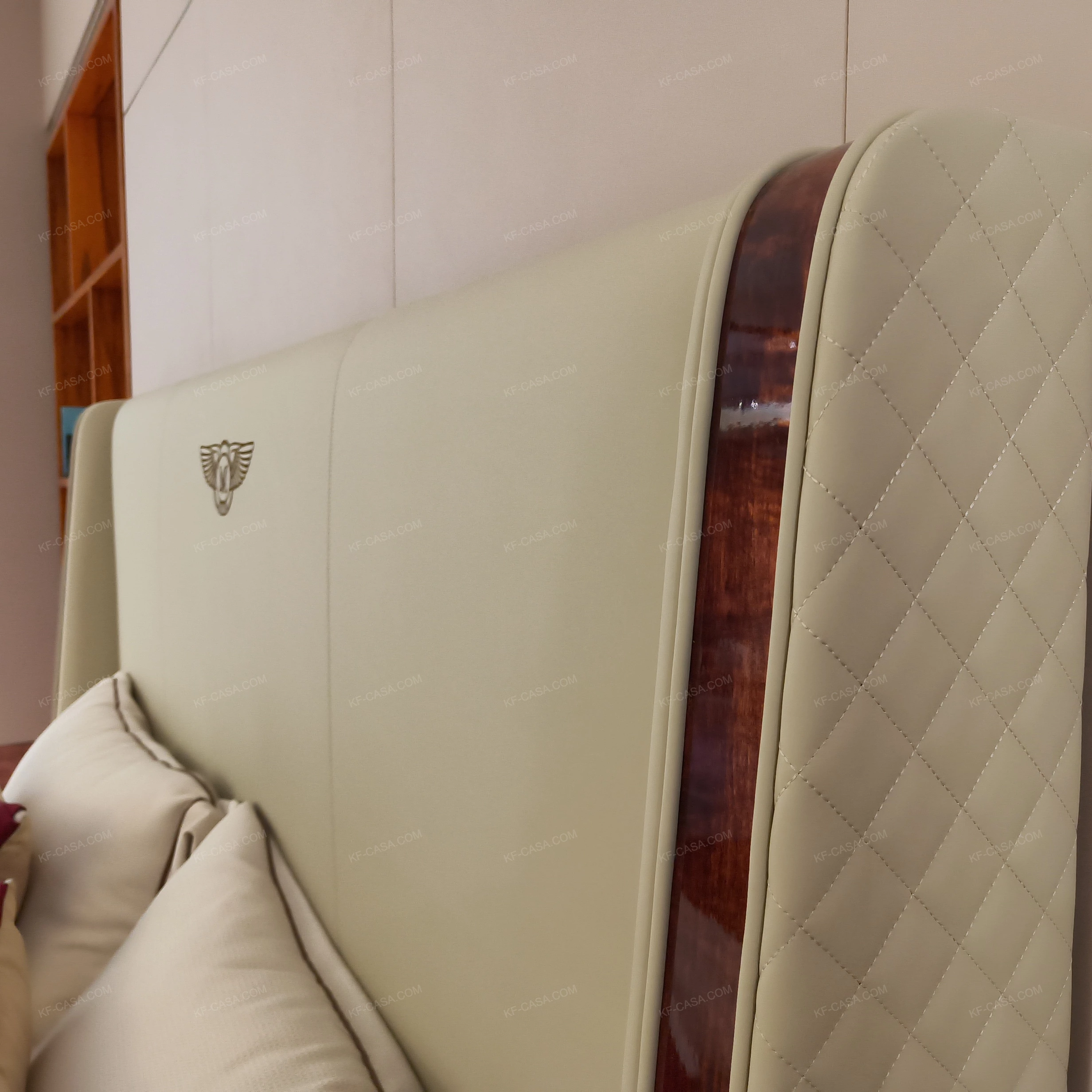 Light Beige Upholstered Bed with Quilted Texture, Natural Wood Veneer Trim & Metal Emblem Accents